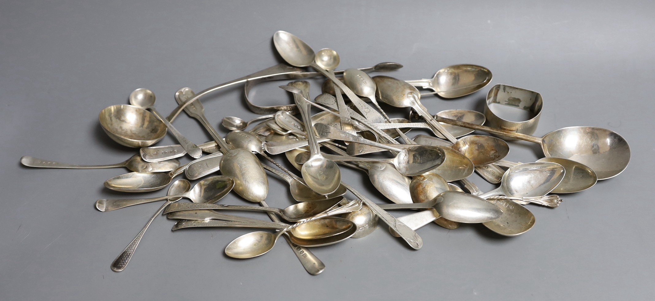 A quantity of mainly 19th century silver teaspoons, various dates and makers and other items including a George III seal top soon, a George IV sauce ladle and a silver napkin ring